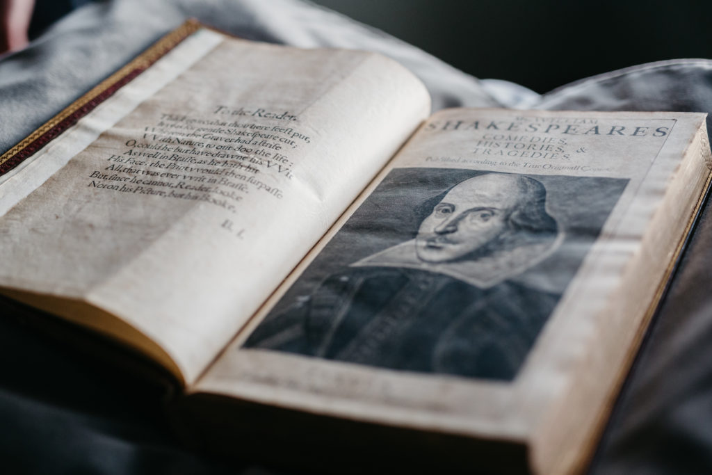 The First Folio, open to a page with a portrait of William Shakespeare.